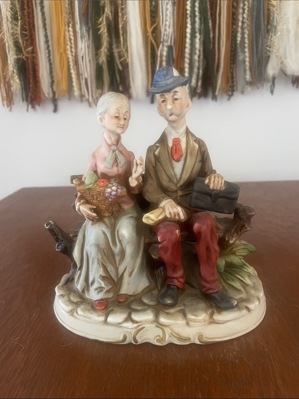 Vintage elderly Couple Figurine sitting on park Bench